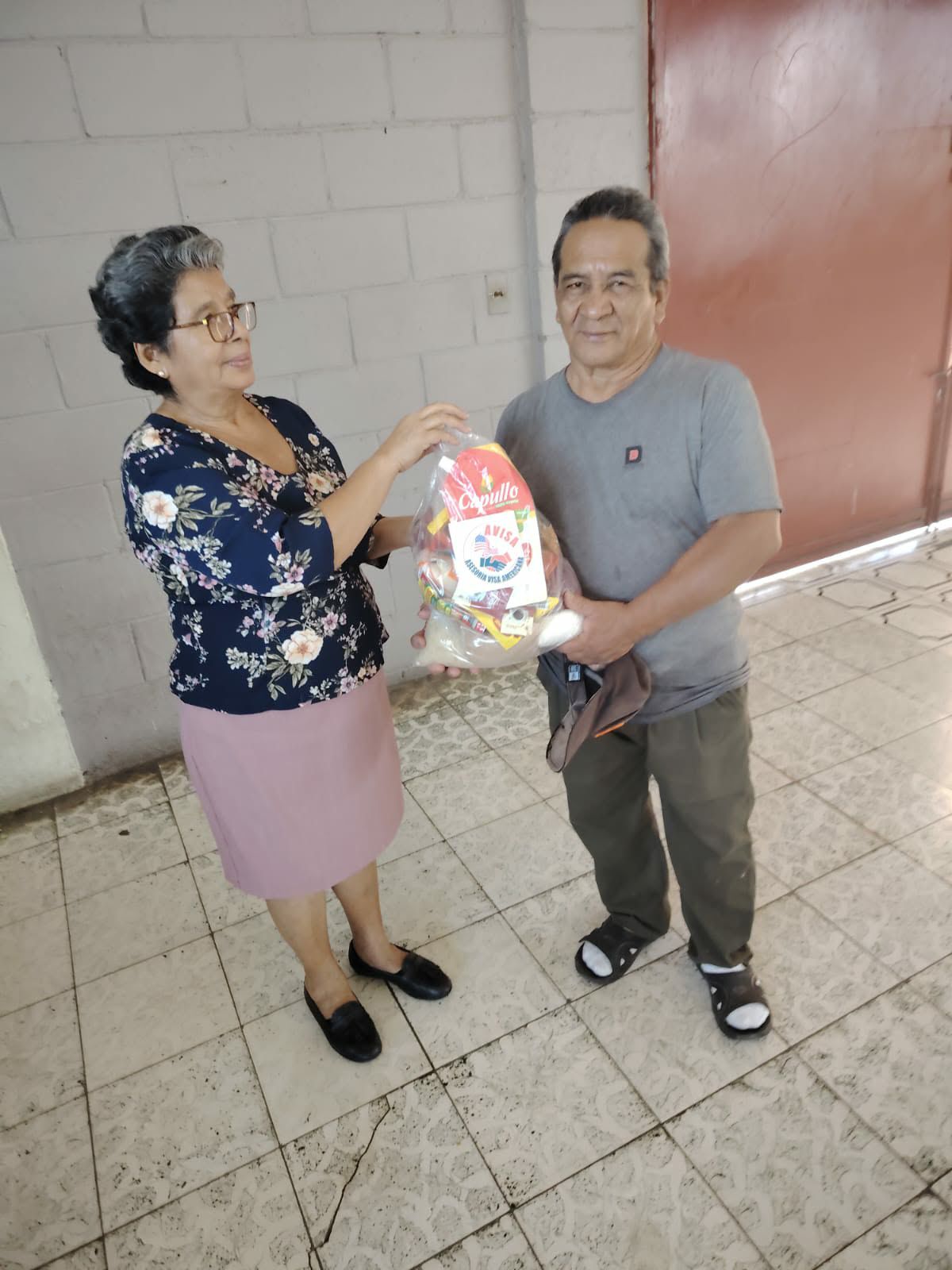 Recipient in sunglasses holding food support