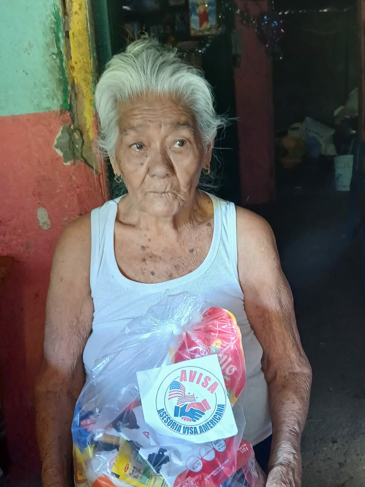 Two people handing over a food support package