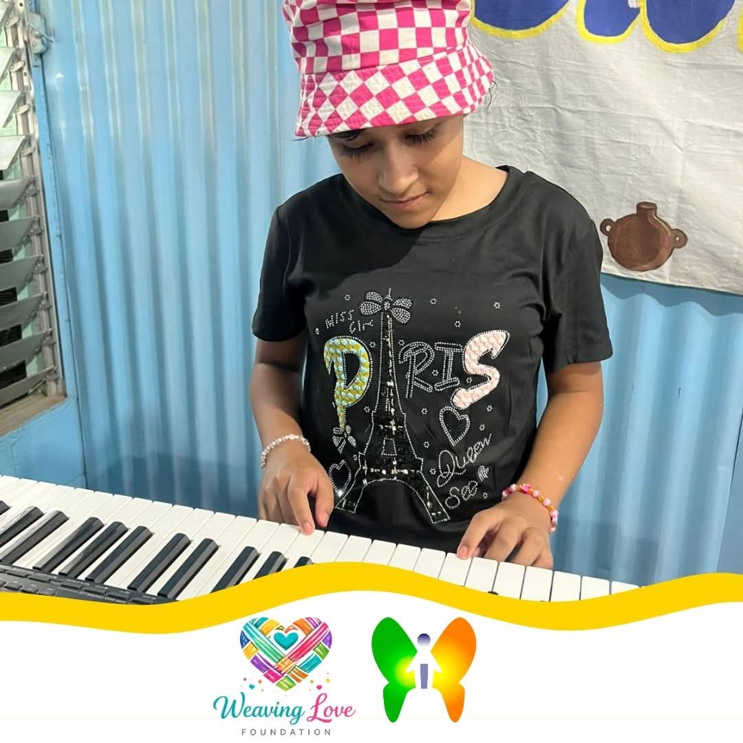 Girl in a green shirt learning keyboard